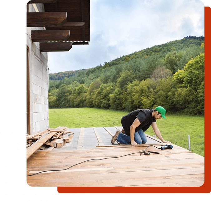 A man working on the deck of his home.