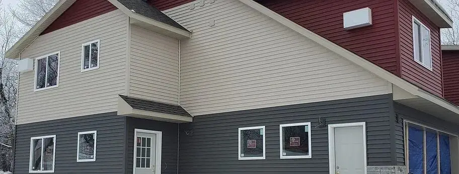 A house with two windows and a door.