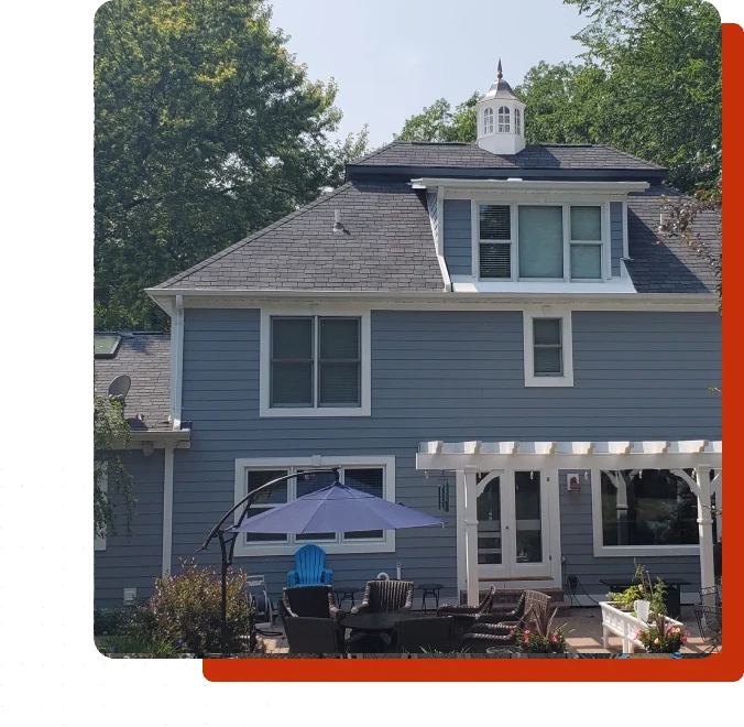 A blue house with a white roof and a black awning.